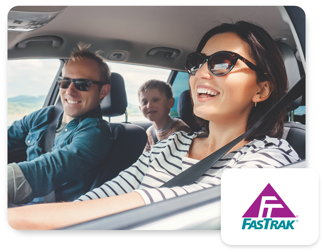 Smiling family driving in their car